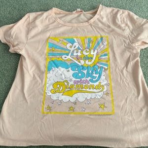 This a GB Girls shirt. It is a size large. with a song from the Beatles on it.